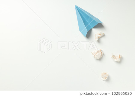 Paper plane and paper balls on white background 102965020