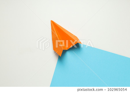 Orange paper plane on white - blue background Orange paper plane on white - blue background 102965054
