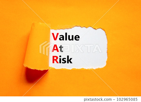 VAR Value at risk symbol. Concept words VAR Value at risk on beautiful white paper. Beautiful orange table orange background. Business and VAR Value at risk concept. Copy space. 102965085