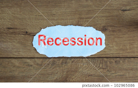 Word recession on the piece of paper. Wood table. 102965086