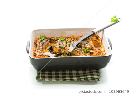 cooked meatballs from minced meat in a sauce in a ceramic form 102965649