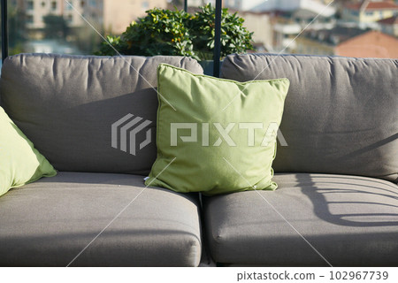 modern grey sofa with pillows in living room at home 102967739