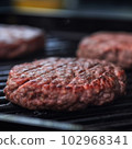 Delicious hamburger patty on grill 102968341
