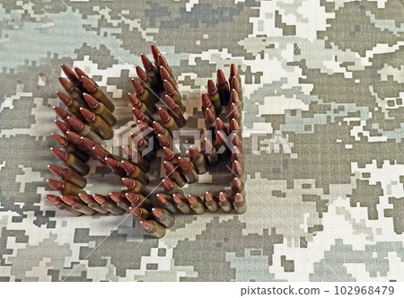 Cartridges for the Kalashnikov assault rifle. War Concept. Pile of bullets 102968479