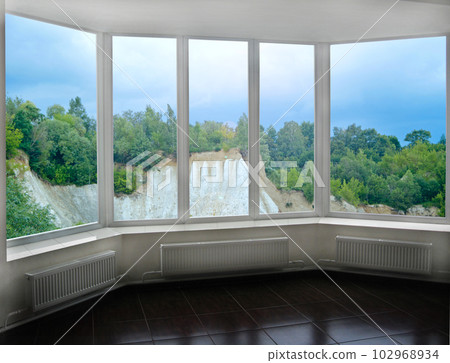Panoramic window overlooking sandy cliff. View of sand pit from window of room Panoramic window overlooking sandy cliff. View of sand pit from window of room 102968934