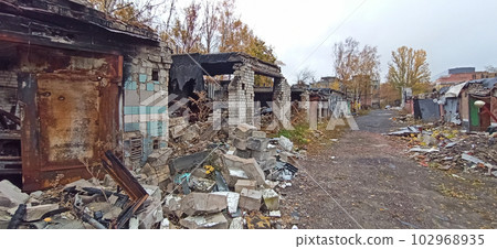 Burnt cars in destroyed garages during war in Ukraine. Russian-Ukrainian War Burnt cars in destroyed garages during war in Ukraine. Russian-Ukrainian War 102968935