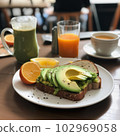 Tasty breakfast with avocado toast and orange juice  102969058
