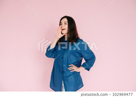 Exciting News Announcement: Positive Girl Expressing Surprise with Hand Near Open Mouth, Sharing 102969477