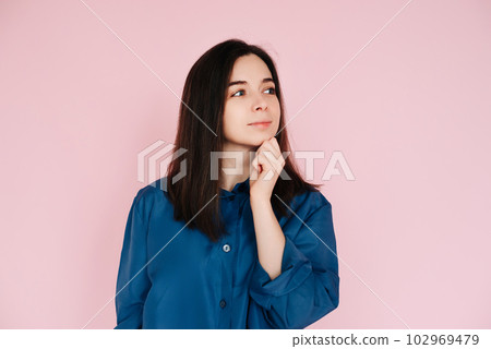 Serenity and Contemplation: Mindful Portrait of a Beautiful Girl with Hand on Chin, Gazing into 102969479