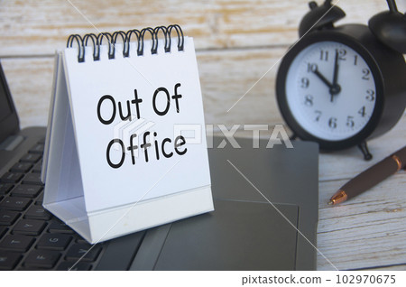 Out of office notification text on white notepad. Out of Office concept Out of office notification text on white notepad. Out of Office concept 102970675