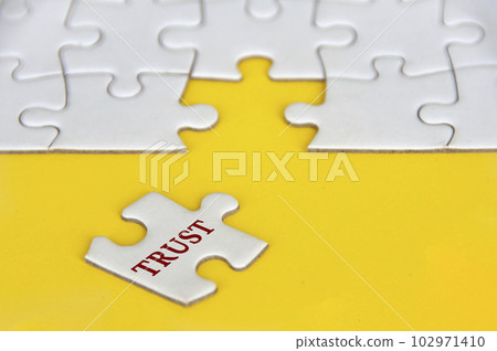 Trust text on missing jigsaw puzzle on yellow background Trust text on missing jigsaw puzzle on yellow background 102971410