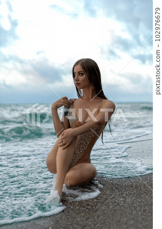 Sexy slim girl in a piece nude swimsuit posing Stock Photo