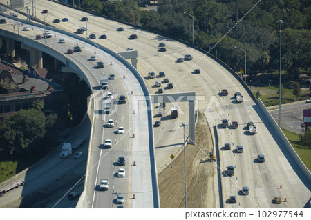 Aerial view of american freeway intersection with fast moving cars and trucks. USA transportation infrastructure concept 102977544