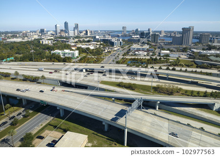 Aerial view of american freeway intersection with fast moving cars and trucks. USA transportation infrastructure concept 102977563