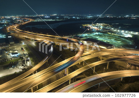 Above view of wide highway crossroads in Tampa, Florida at night with fast driving cars. USA transportation infrastructure concept 102977726