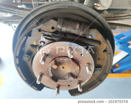 rusty car drum brake without cover hub, maintenance brake system at car auto garage shop rusty car drum brake without cover hub, maintenance brake system at car auto garage shop 102978358