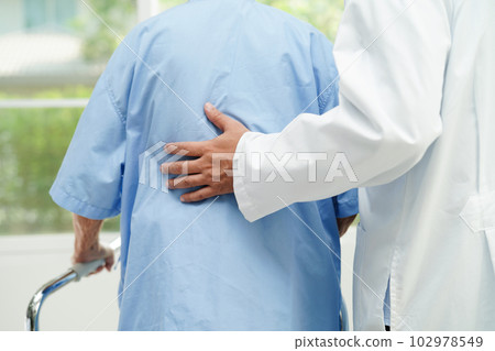 Doctor help Asian elderly woman disability patient walk with walker in nursing hospital, medical concept. Doctor help Asian elderly woman disability patient walk with walker in nursing hospital, medical concept. 102978549