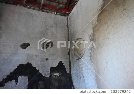 old scary interior burn house, cement wall and wood floor 102979242