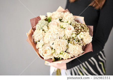 Beautiful bouquet of flowers in woman hand. Floral shop concept . Beautiful fresh cut bouquet. Flowers delivery Beautiful bouquet of flowers in woman hand. Floral shop concept . Beautiful fresh cut bouquet. Flowers delivery 102981551
