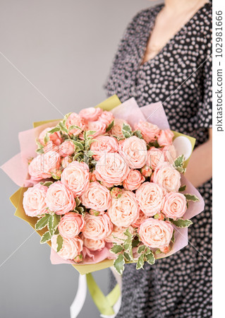 Beautiful bouquet of mixed flowers in woman hand. Floral shop concept . Beautiful fresh cut bouquet. Flowers delivery 102981666