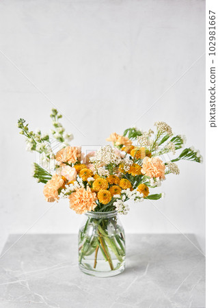 Finished flower arrangement in a vase for home. Flowers bunch, set for interior. Fresh cut flowers for decoration home. European floral shop. Delivery fresh cut flower. 102981667