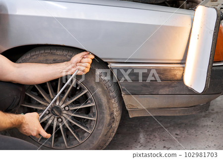 Removing dents on the car. PDR technology. Car body repair without painting. 102981703