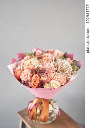 Finished flower arrangement in a vase for home. Flowers bunch, set for interior. Fresh cut flowers for decoration home. European floral shop. Delivery fresh cut flower. 102981715