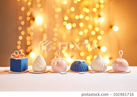 Merry Christmas card. Variety of sweet delicious cakes. Fir branches on a gray background. Merry Christmas card. New year mood Merry Christmas card. Variety of sweet delicious cakes. Fir branches on a gray background. Merry Christmas card. New year mood 102981716