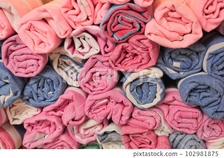 colorful fabrics, bedspreads and kerchiefs with different oriental patterns.  102981875