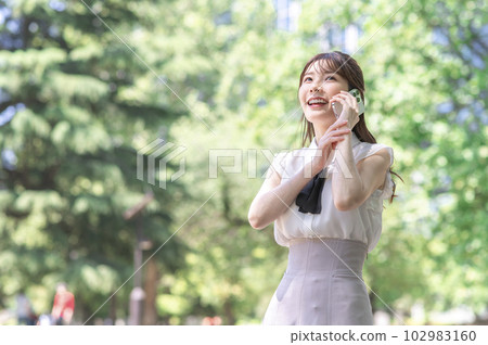 A young woman talking on a smartphone A young woman talking on a smartphone 102983160