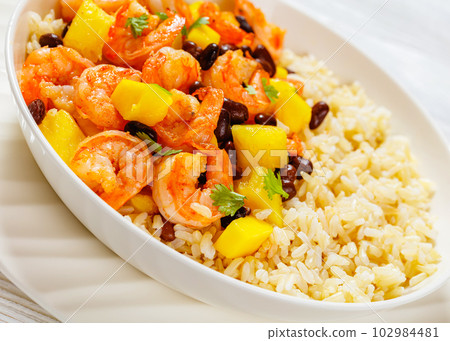 shrimps with beans, mango, brown rice in bowl shrimps with beans, mango, brown rice in bowl 102984481