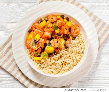 shrimps with beans, mango, brown rice in bowl shrimps with beans, mango, brown rice in bowl 102984483