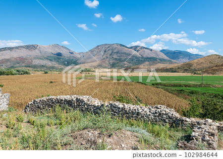 Idyllic valley with agricultural fields surrounded by mountains in southern Albania 102984644
