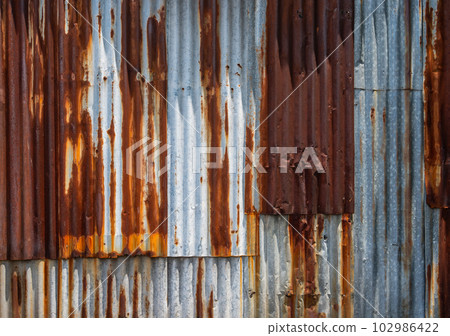 Rusty corrugated galvanised iron wall texture for background. 102986422