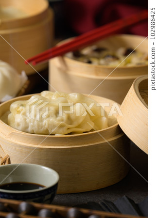 Chinese steamed pork shumai. Bamboo steamers with assorted dim sum, Chinese cuisine 102986425