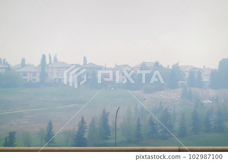Calgary, Alberta, Canada. May 18, 2023. Panorama hills neighbourhood, view of the poor quality air due to wildfires. Concept Calgary, Alberta, Canada. May 18, 2023. Panorama hills neighbourhood, view of the poor quality air due to wildfires. Concept 102987100