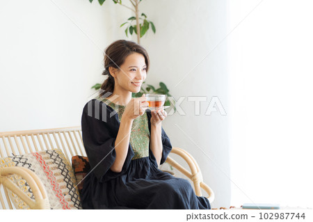 Photo of a woman drinking tea 102987744