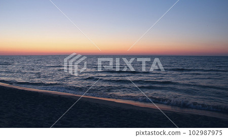 Sunset on Baltic Sea. Waves on seashore in evening Sunset on Baltic Sea. Waves on seashore in evening 102987975