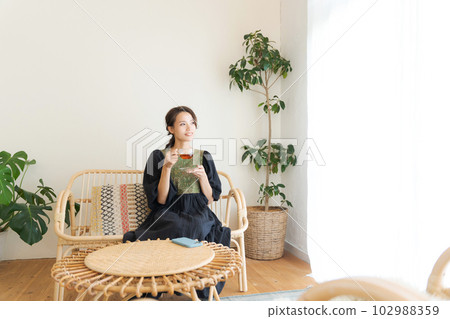 Photo of a woman drinking tea Photo of a woman drinking tea 102988359