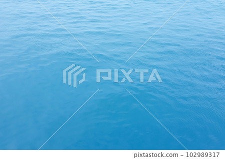 Blue Sea surface aerial view with waves from a drone, empty blank to background. soft focus. 102989317
