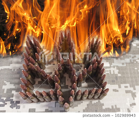 Ukrainian coat of arms made by patrons in fire. war in burning Ukraine 102989943