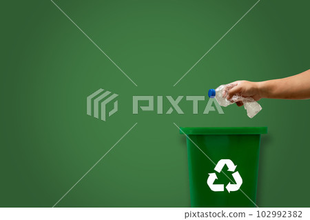 Plastic green into the recycling bin For plastic, ecological glass, and paper copy space, green background Plastic green into the recycling bin For plastic, ecological glass, and paper copy space, green background 102992382