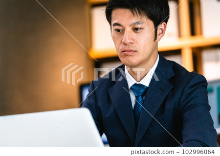 businessman thinking at computer businessman thinking at computer 102996064