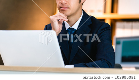 businessman thinking at computer businessman thinking at computer 102996081