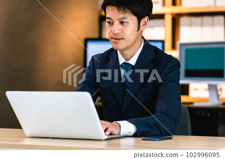 businessman thinking at computer 102996095