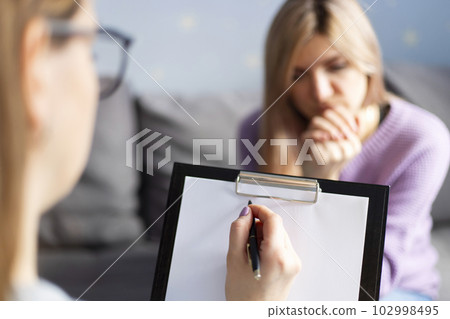 Psychotherapy session, a woman is talking with her psychologist at her office 102998495