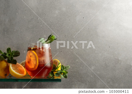 Iced tea with lemon and mint on the background of the grey concrete wall. 103000411