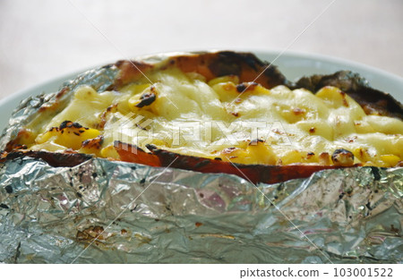 baking Japanese yam stuffing sweet corn seed with cheese in foil on plate baking Japanese yam stuffing sweet corn seed with cheese in foil on plate 103001522