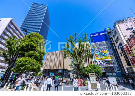 Tokyo cityscape in Japan May. A view of Hareza Ikebukuro at the east exit of Ikebukuro Station and fresh greenery shining against the blue sky 103003352