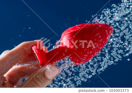 Woman washing red anal plug under shower on... - Stock Photo [103003373] -  PIXTA